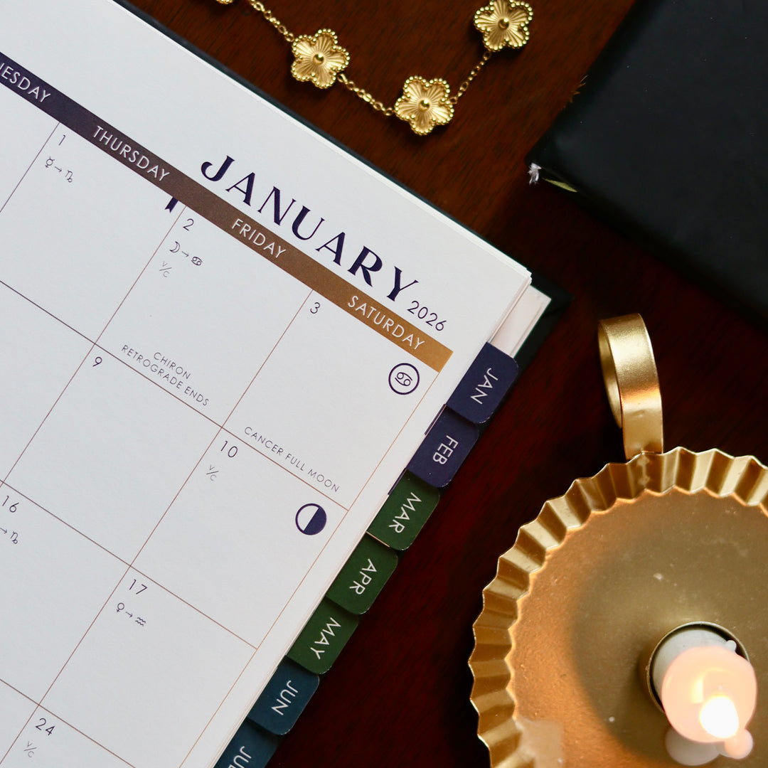 Calendar for January 2026 with decorative items on a wooden surface