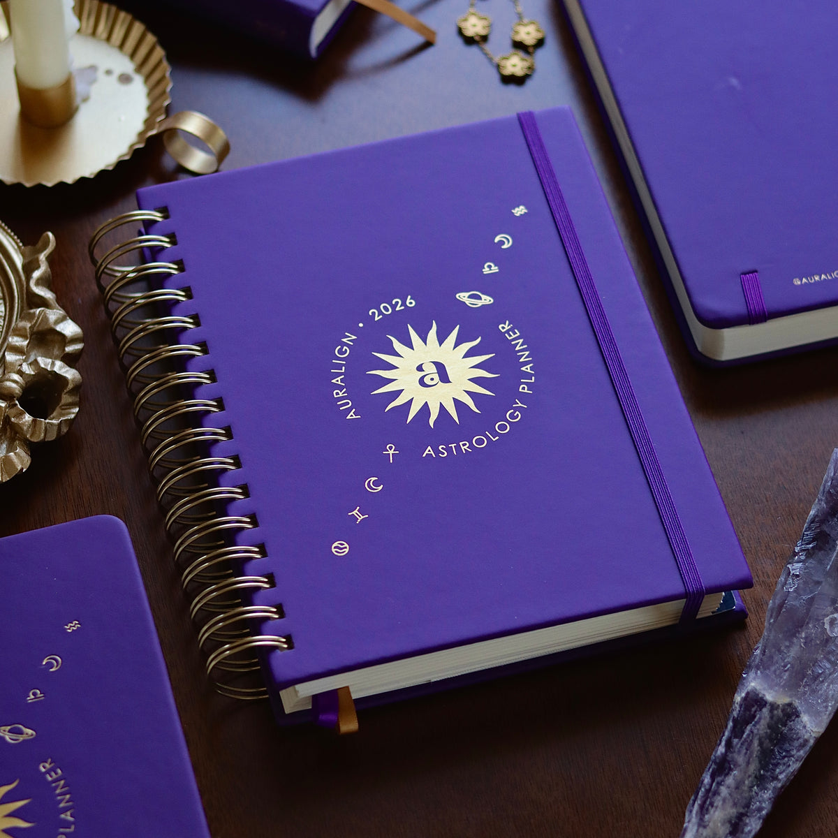 Purple planner with astrological design on a wooden surface